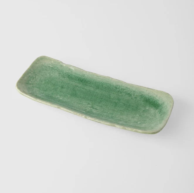Green ceramic tray on a white background