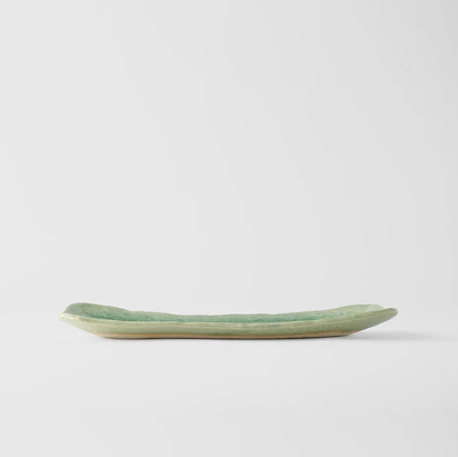 Green ceramic tray on a white background