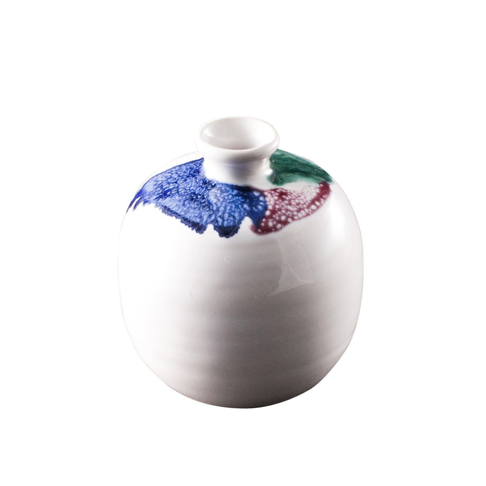 White ceramic vase with colorful abstract design on a white background