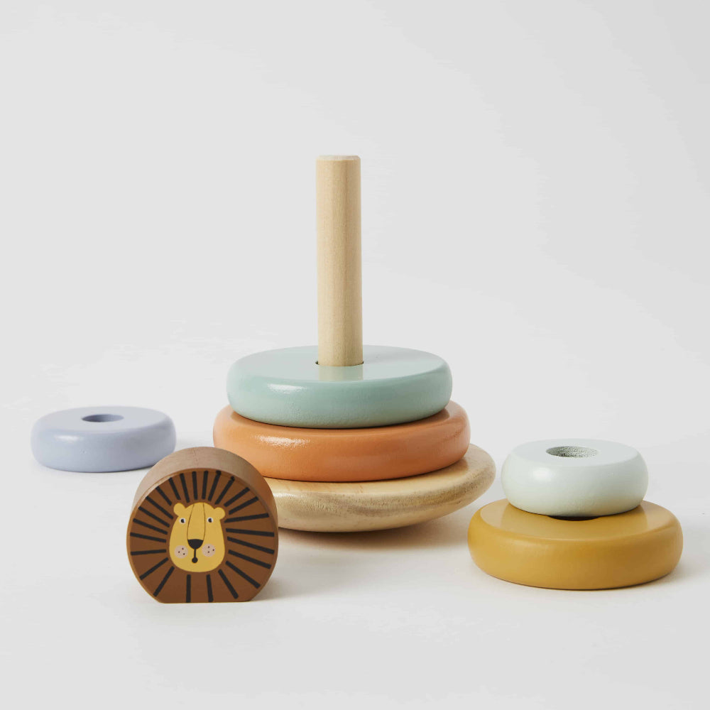 Stack of colorful wooden rings with a lion design on top against a white background