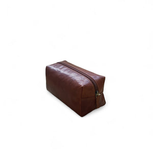 Brown leather toiletry bag  on a white background