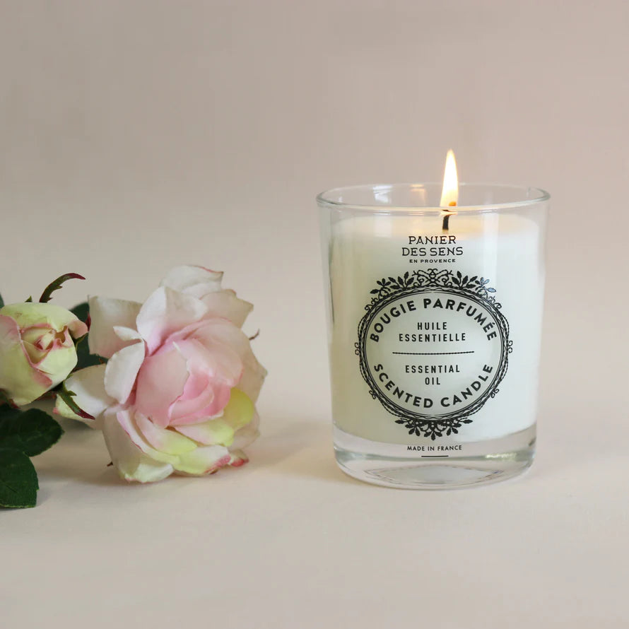 Scented candle with floral design and label on a white background