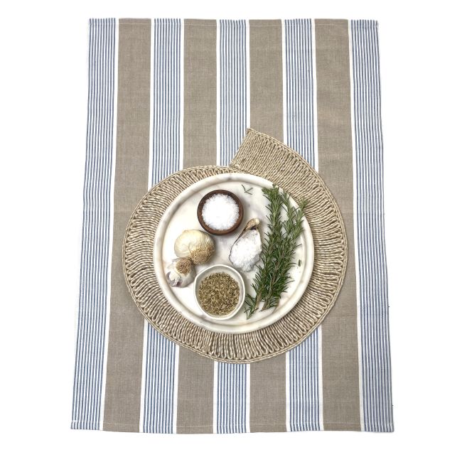 Decorative plate with herbs and small items on a striped teatowel