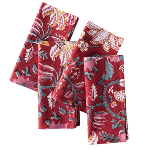 Set of four red floral patterned napkins on a white background