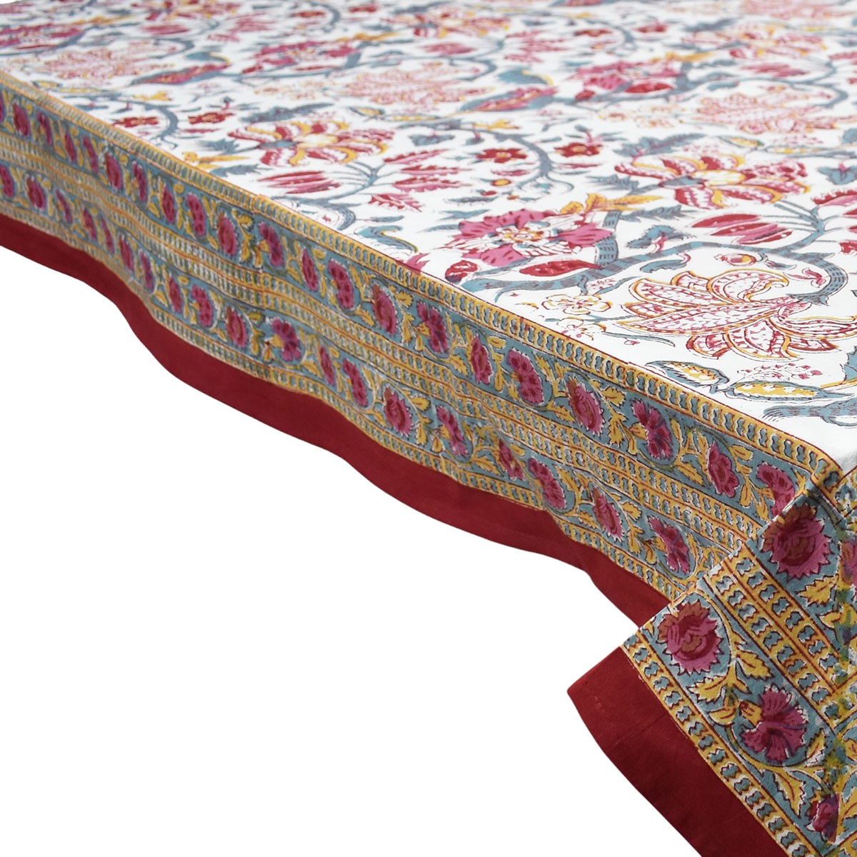 Decorative tablecloth with floral pattern and red border on a white background