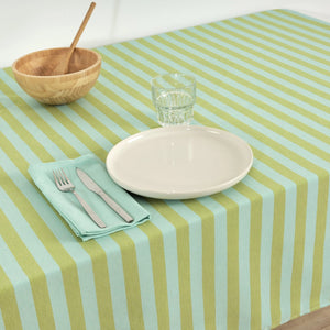 Striped tablecloth with a plate, glass, bowl, and cutlery on a white background