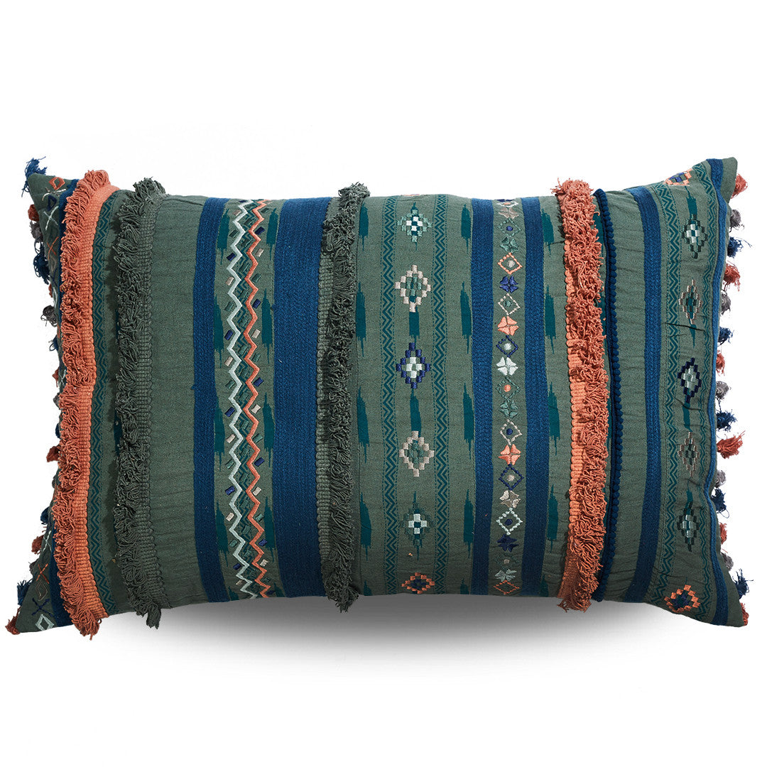 Decorative pillow with tribal patterns and fringes on a white background