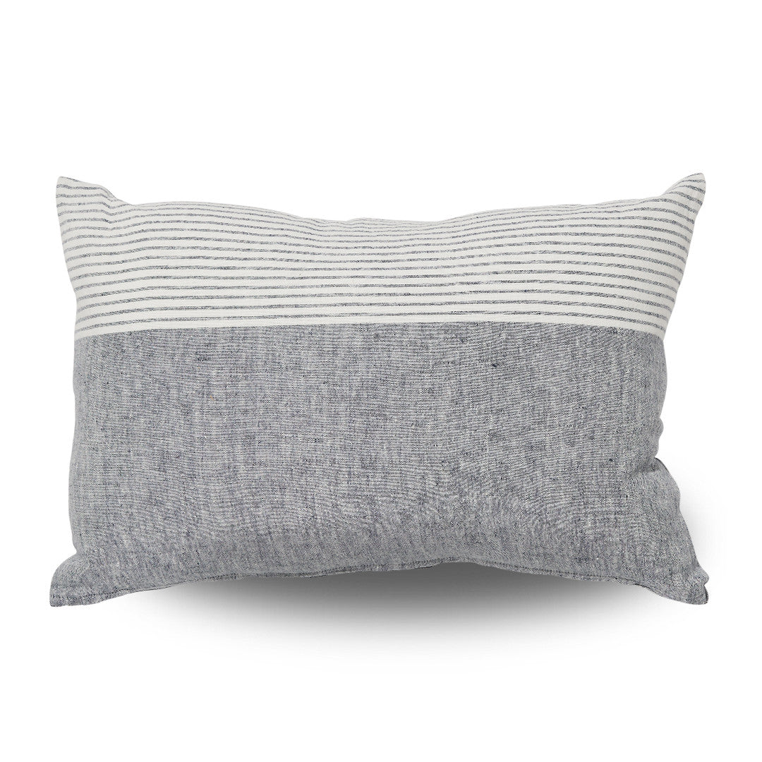 Two-tone pillow with striped top and solid bottom on a white background