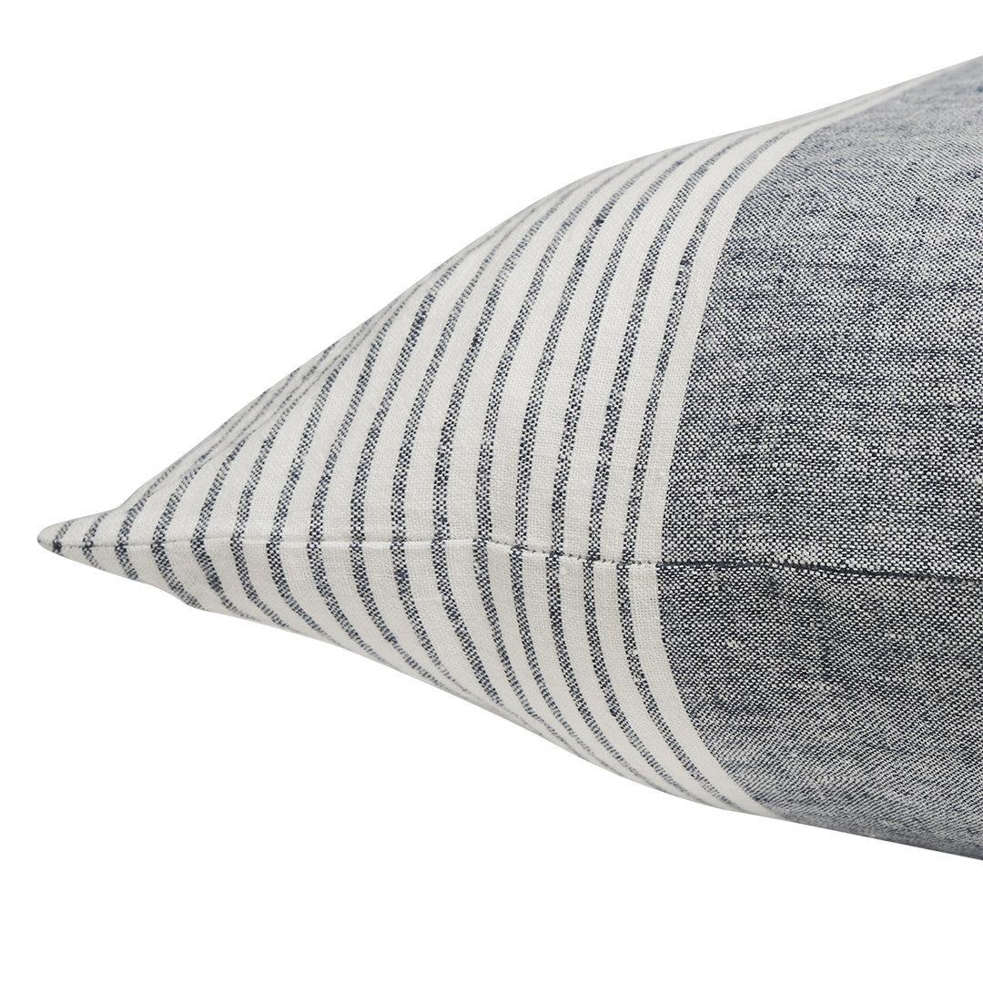 Two-tone pillow with striped top and solid bottom on a white background