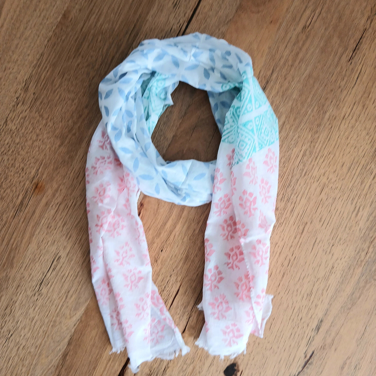 Floral patterned scarf on a wooden surface