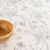 Floral patterned tablecloth with a wooden bowl on a white background