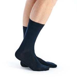 A pair of dark navy crew socks worn on a person's feet, shown from the calf down against a plain white background.