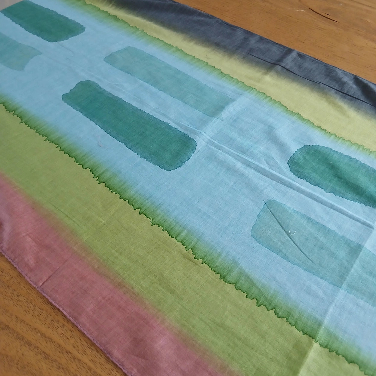 Colorful scarf draped over a wooden surface