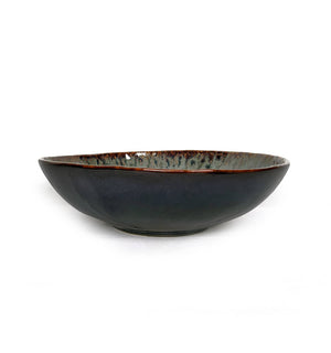 A wide, shallow ceramic bowl with a dark charcoal gray exterior and a speckled, metallic bronze interior, shown on a plain white background.