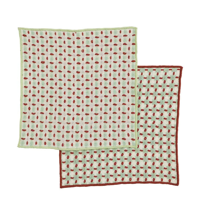 Two patterned cloths with red and green design on a white background