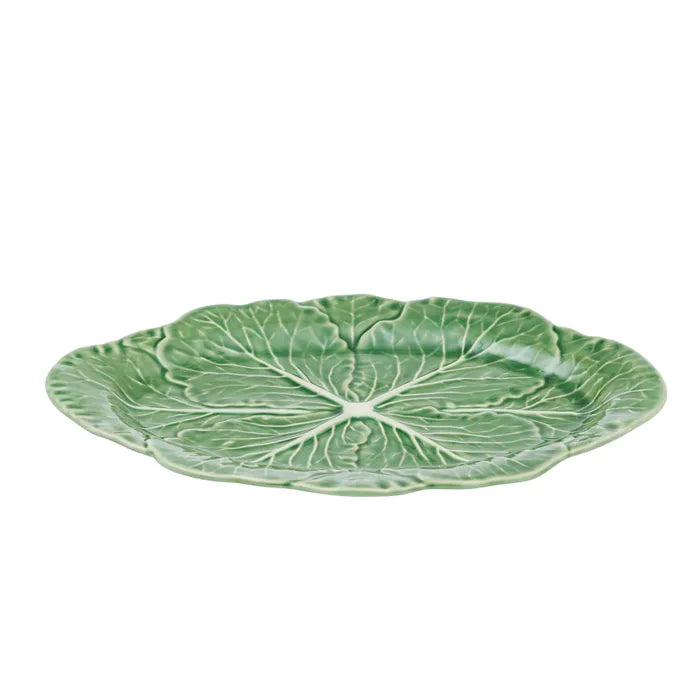 Green ceramic plate with leaf pattern on a white background