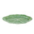 Green ceramic plate with leaf pattern on a white background