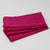 Stack of pink napkins on a light gray background