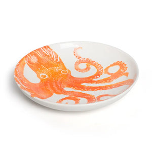 White plate with orange octopus design on a white background