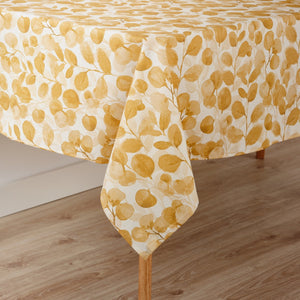 Yellow leaf patterned tablecloth on a wooden table
