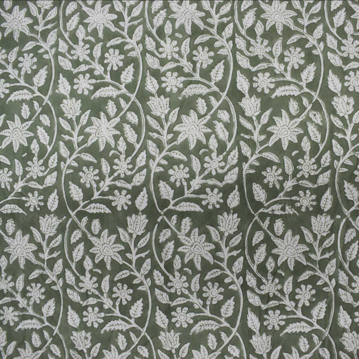 Green and white patterned tablecloth with matching napkin on a white background