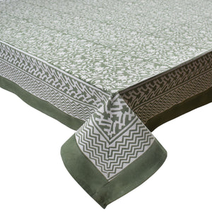 Green and white patterned tablecloth with matching napkin on a white background