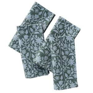 Set of four green fabric napkins with floral patterns on a white background
