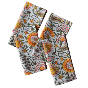 Four floral-patterned fabric Napkins on a white background