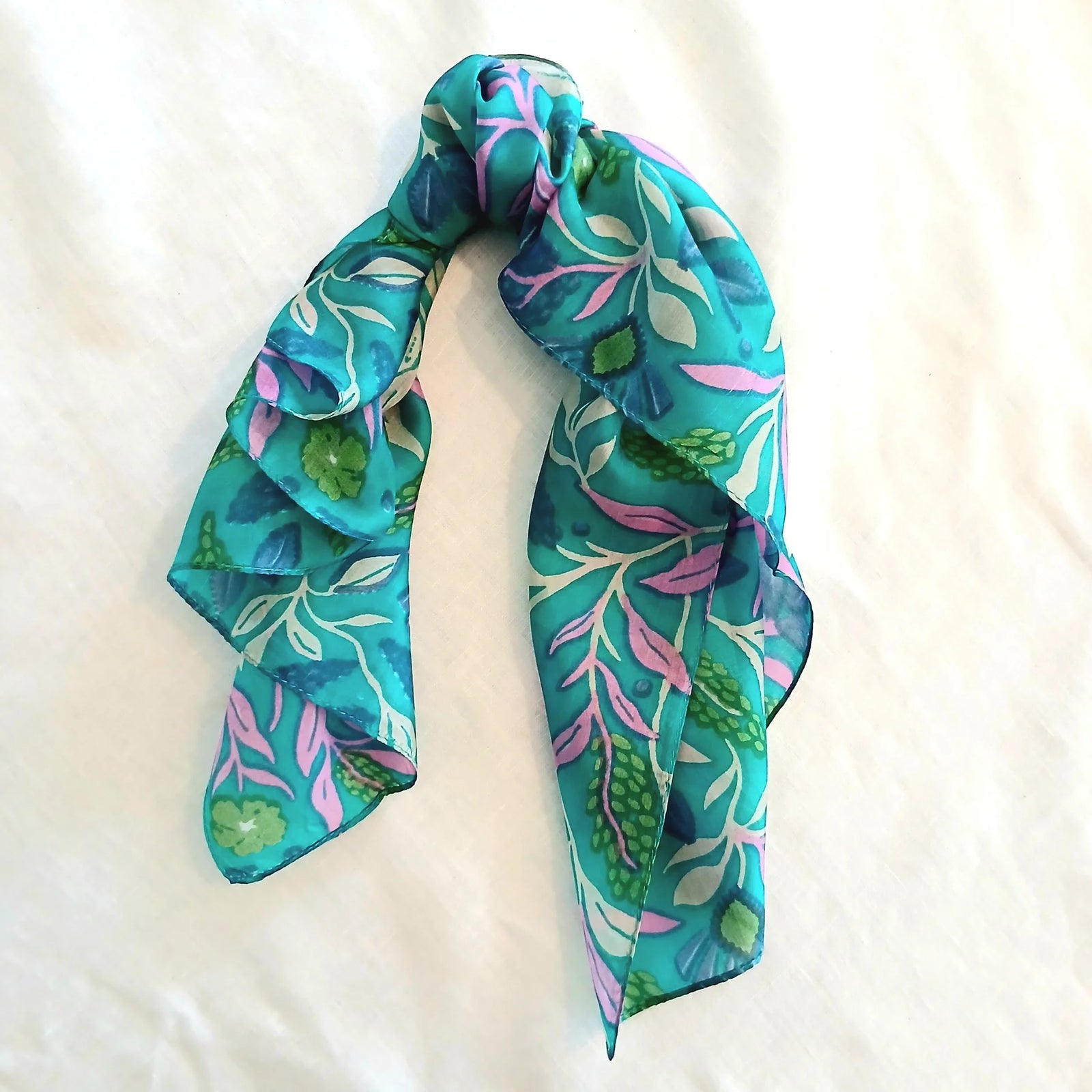 Turquoise floral scarf on a white background