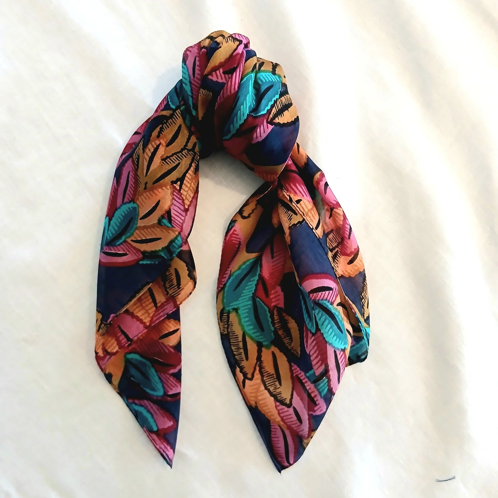 Colorful scarf with leaf pattern on a white background