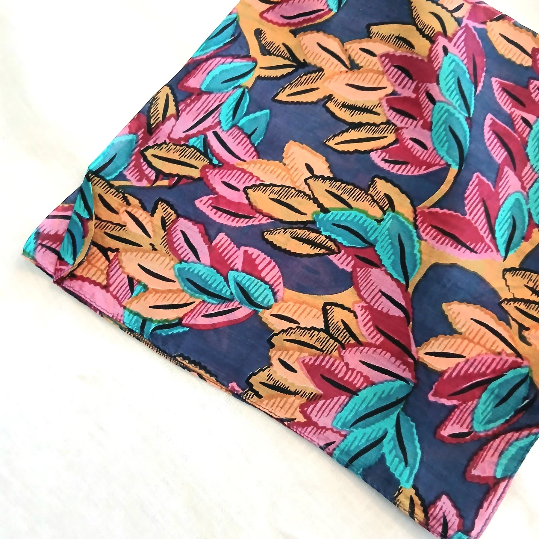 Colorful scarf with leaf pattern on a white background