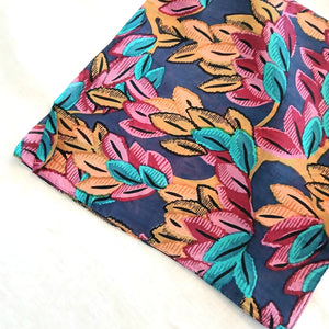 Colorful scarf with leaf pattern on a white background