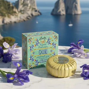 Capri soap and packaging with a scenic background of blue water and white cliffs.