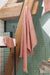 Zoe guest towel-textured-with fringe-shown hanging in a bathroom